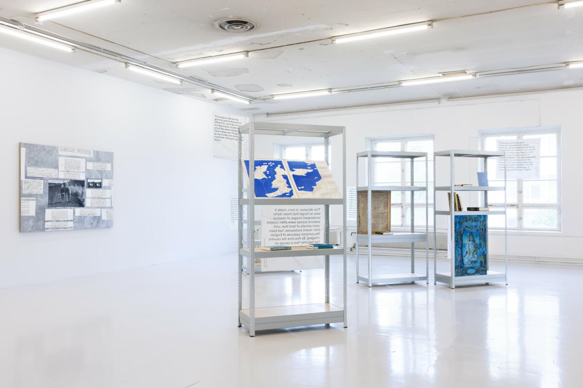 Installation of several pieces of text-based works and paintings in a gallery.